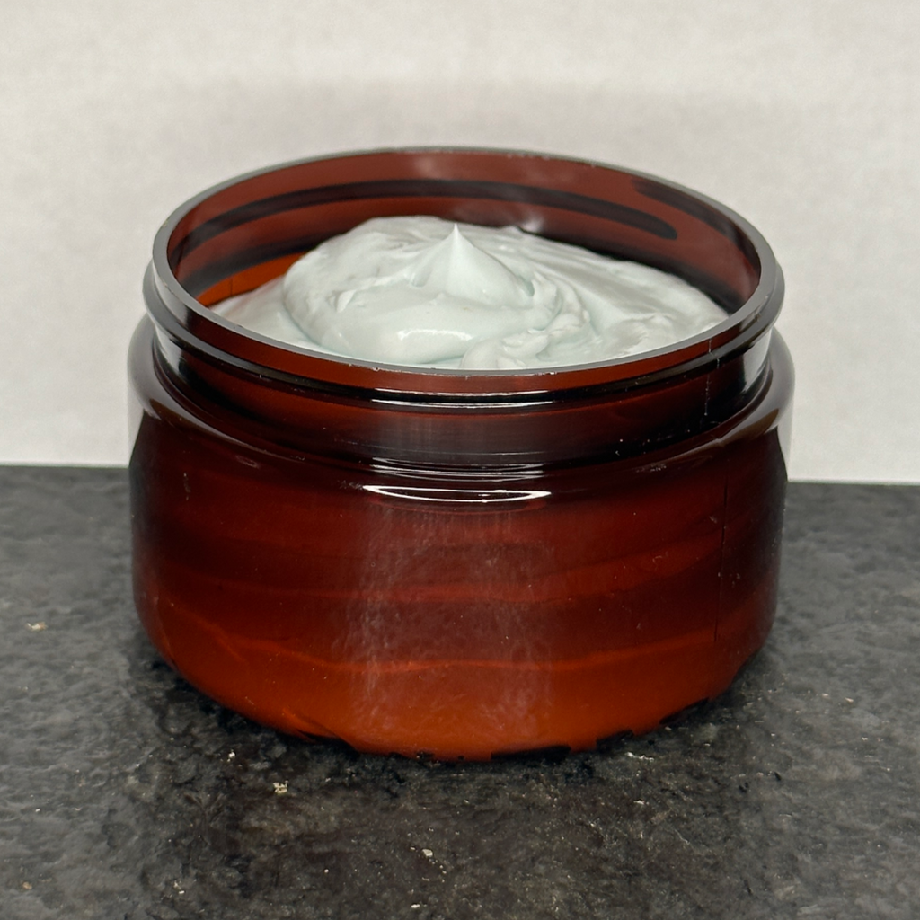 Jar of Amish Heart Blue Cream Organic Pain Relief Cream, showcasing its all-natural ingredients for effective pain relief and soothing application