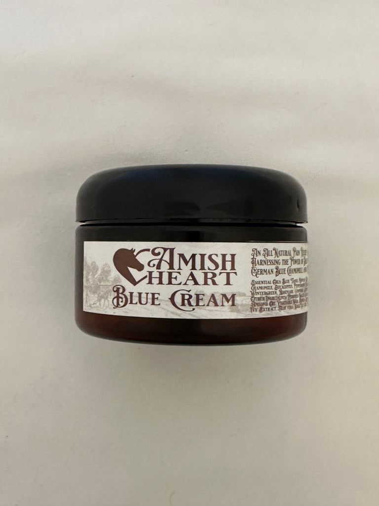 Jar of Amish Heart Blue Cream Organic Pain Relief Cream, showcasing its all-natural ingredients for effective pain relief and soothing application.