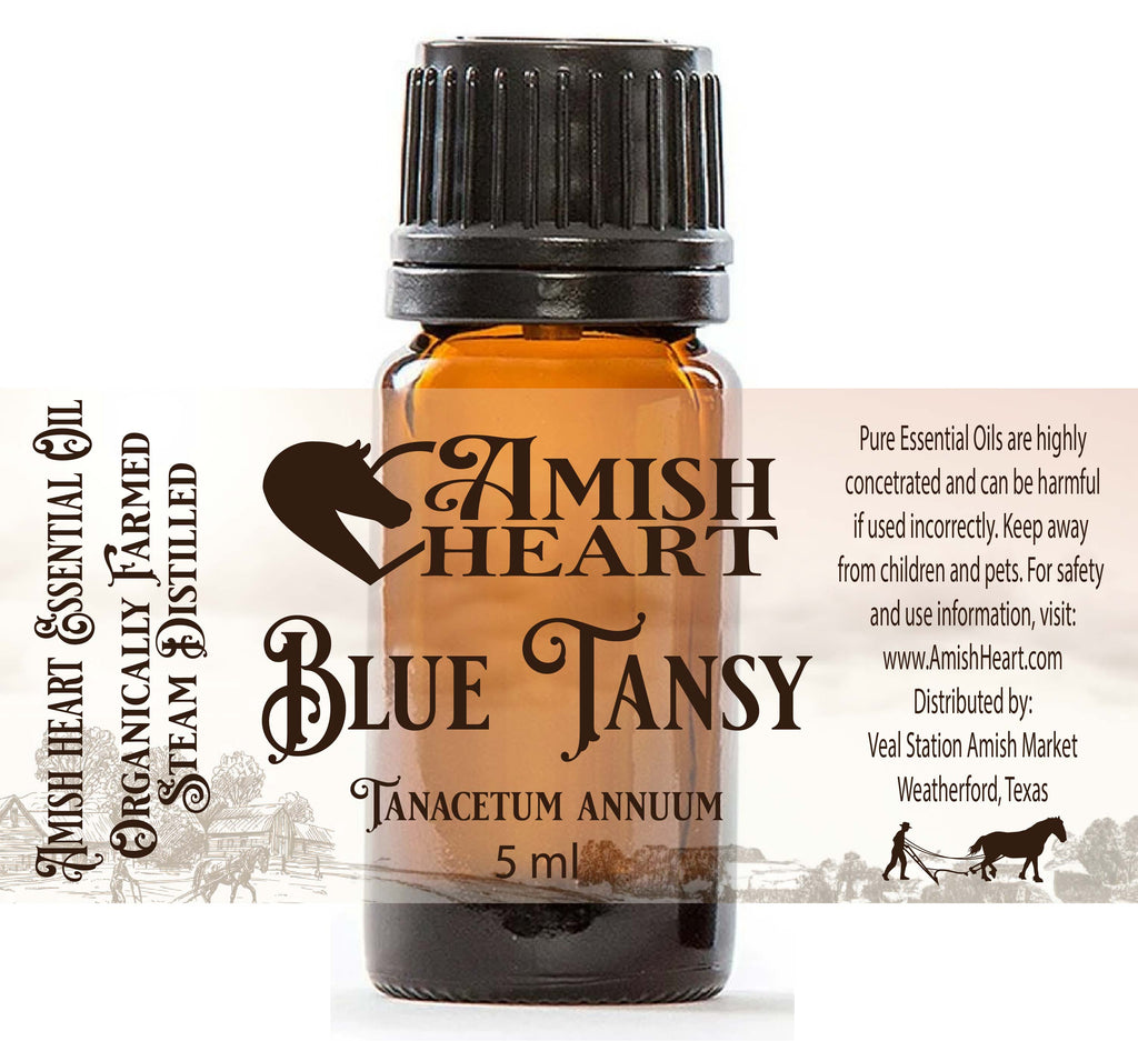 Bottle of Amish Heart Blue Tansy Essential Oil, showcasing its rich blue color and potent therapeutic properties for anti-inflammatory and skin healing benefits.