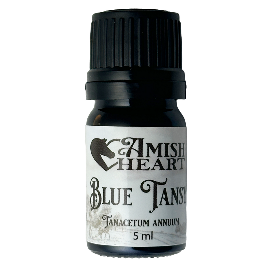 Bottle of Amish Heart Blue Tansy Essential Oil, showcasing its rich blue color and potent therapeutic properties for anti-inflammatory and skin healing benefits.